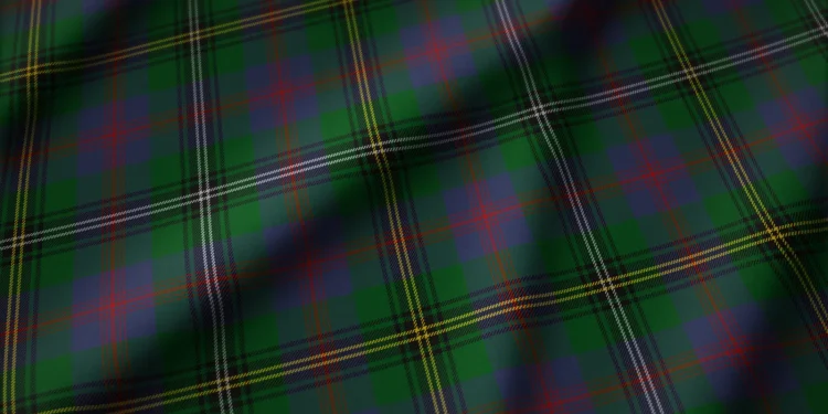 Dark green tartan plaid fabric with intersecting red, yellow, and thin white stripes; the classic check pattern feels bold and traditional.