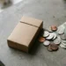 Unbranded cigarette pack on a counter next to US cash and coins