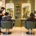 Stylists attending to clients inside a modern unisex hair salon in India