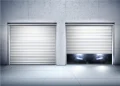 Two metal roll-up garage doors in a concrete wall; the left is closed, while the right is partly open with bright headlights glowing beneath, creating a sleek, dramatic mood.