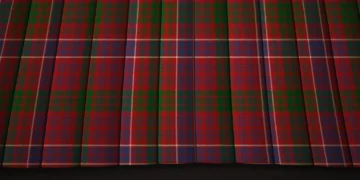 Red-and-green plaid fabric hangs in deep vertical folds, with fine blue and yellow lines crossing the tartan pattern for a rich, formal look.