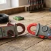Older and newer digital clamp meters compared side by side on a workbench
