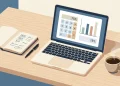 Laptop showing an online business calculator next to a notebook of figures